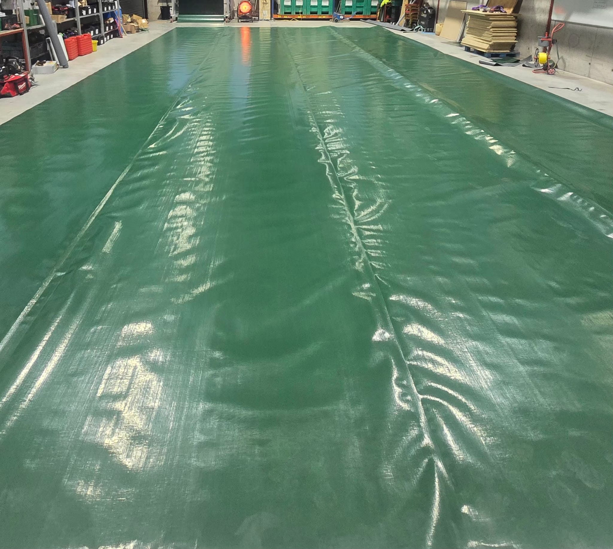 Green Nicolon cover being manufactured in welding facility